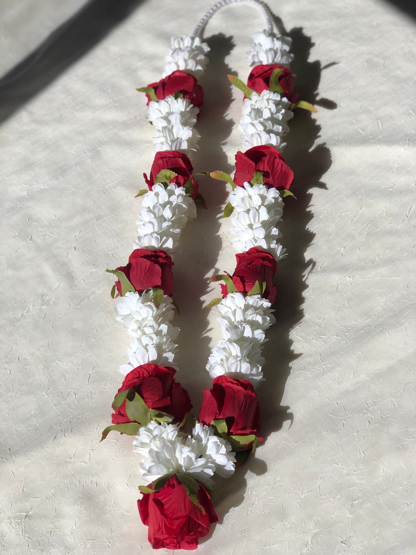 White flower and red rose garland